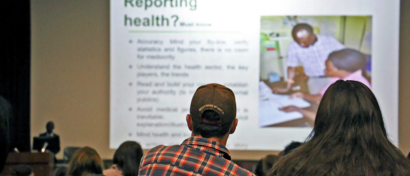 Visitors watch a presentation on 'Reporting Health' during the Global Health Conference.